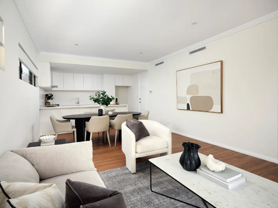 Modern open-plan living room with neutral decor, stylish furniture, and a minimalist aesthetic.