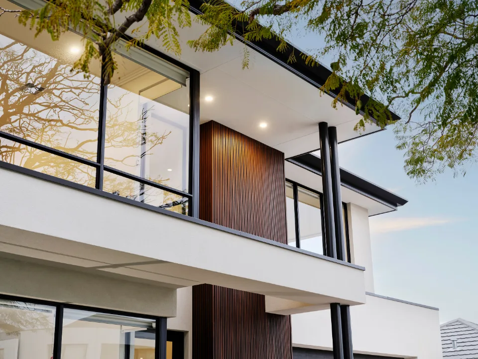 Contemporary house exterior with large windows and modern architectural design.