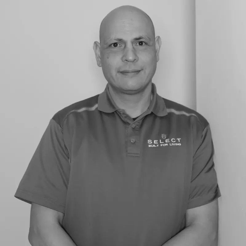 Adam M, Draftsperson. Professional black and white headshot, smiling in a branded polo shirt.