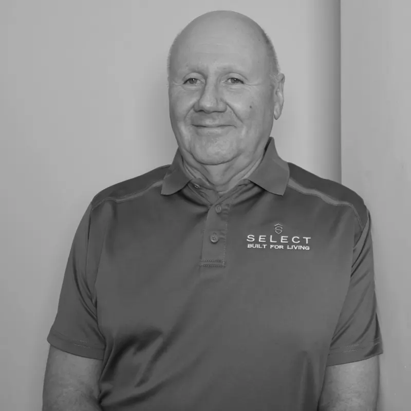 Riley HJ, Senior Scheduler. Professional black and white headshot, smiling in a branded polo shirt.