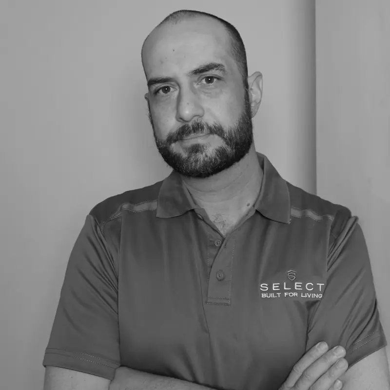 Harley P, Draftsperson. Professional black and white headshot, with a beard, in a branded polo shirt.