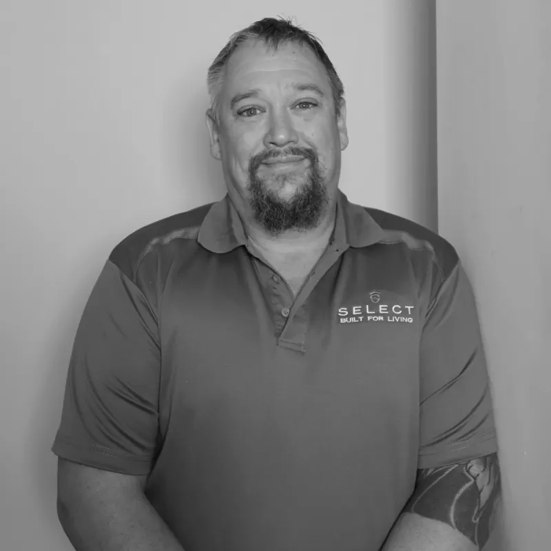 Jamie M, Construction Manager South. Professional black and white headshot, with a beard, in a branded polo shirt.