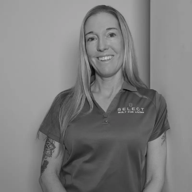 Lynley K, Design Manager. Professional black and white headshot, smiling in a branded polo shirt.