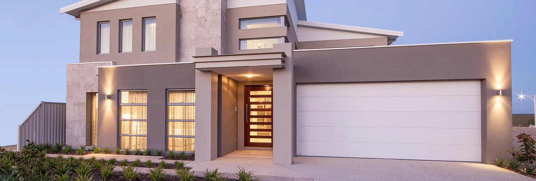 Modern two-story house with large windows and a minimalist design.
