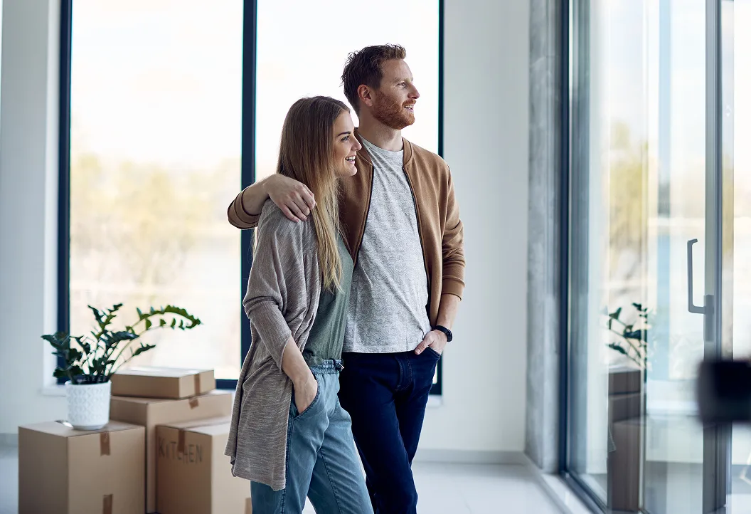 Couple standing together inside their newly built modern home in Australia, enjoying the start of their Select Living home journey.