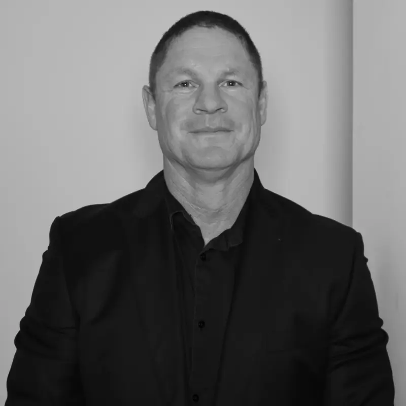 Jason Howard, General Manager. Professional headshot of him in a dark collared shirt and jacket.